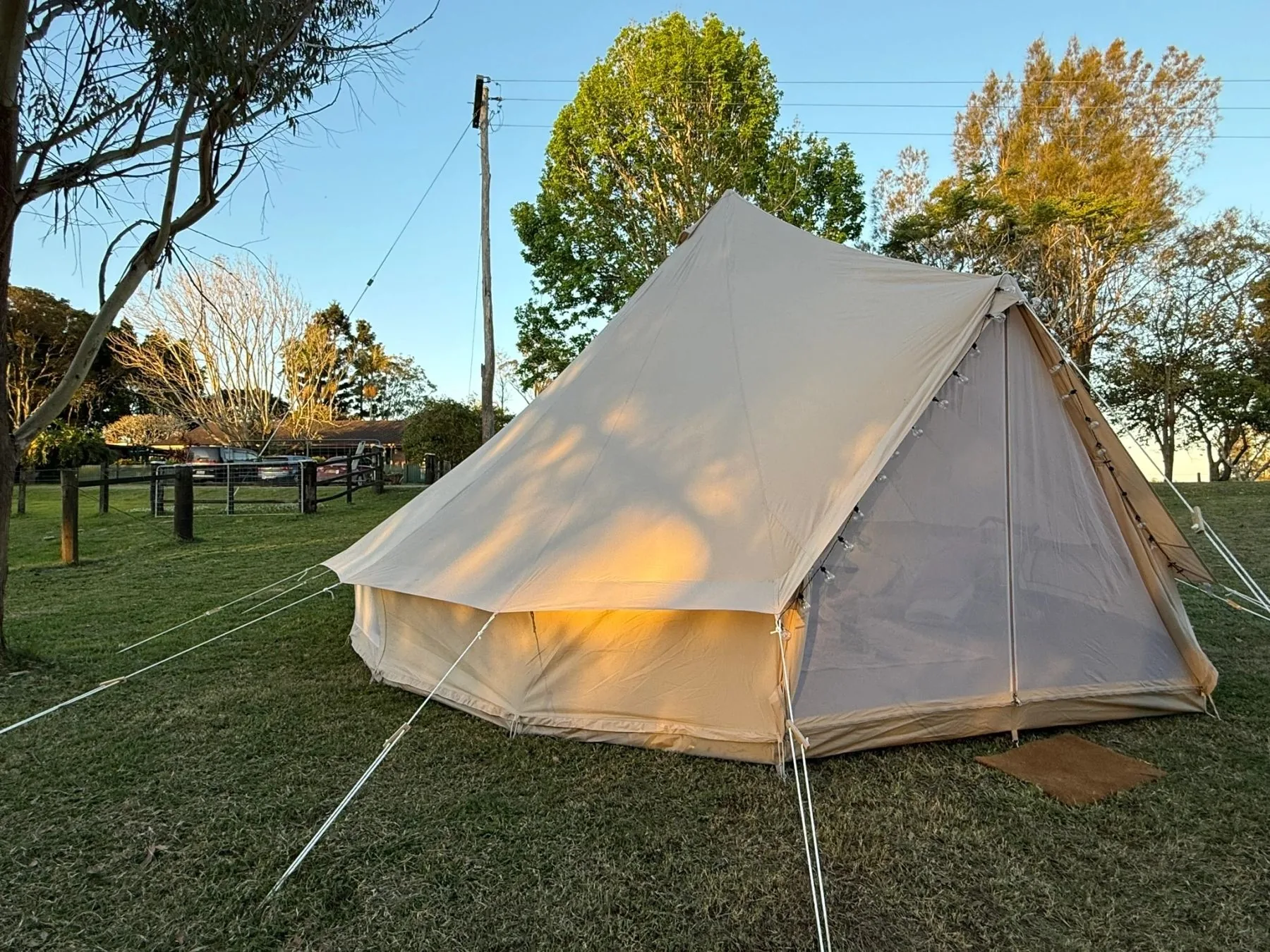 Canvas & Comfort bell tent set up on grass at golden hour in the Northern Rivers