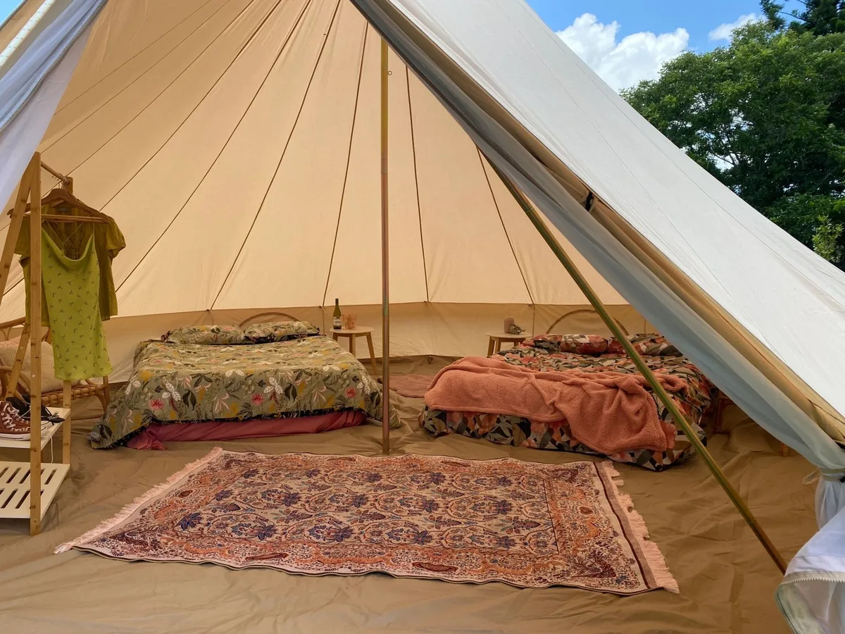 Chic Bell tent styled with matching decor and bedside tables