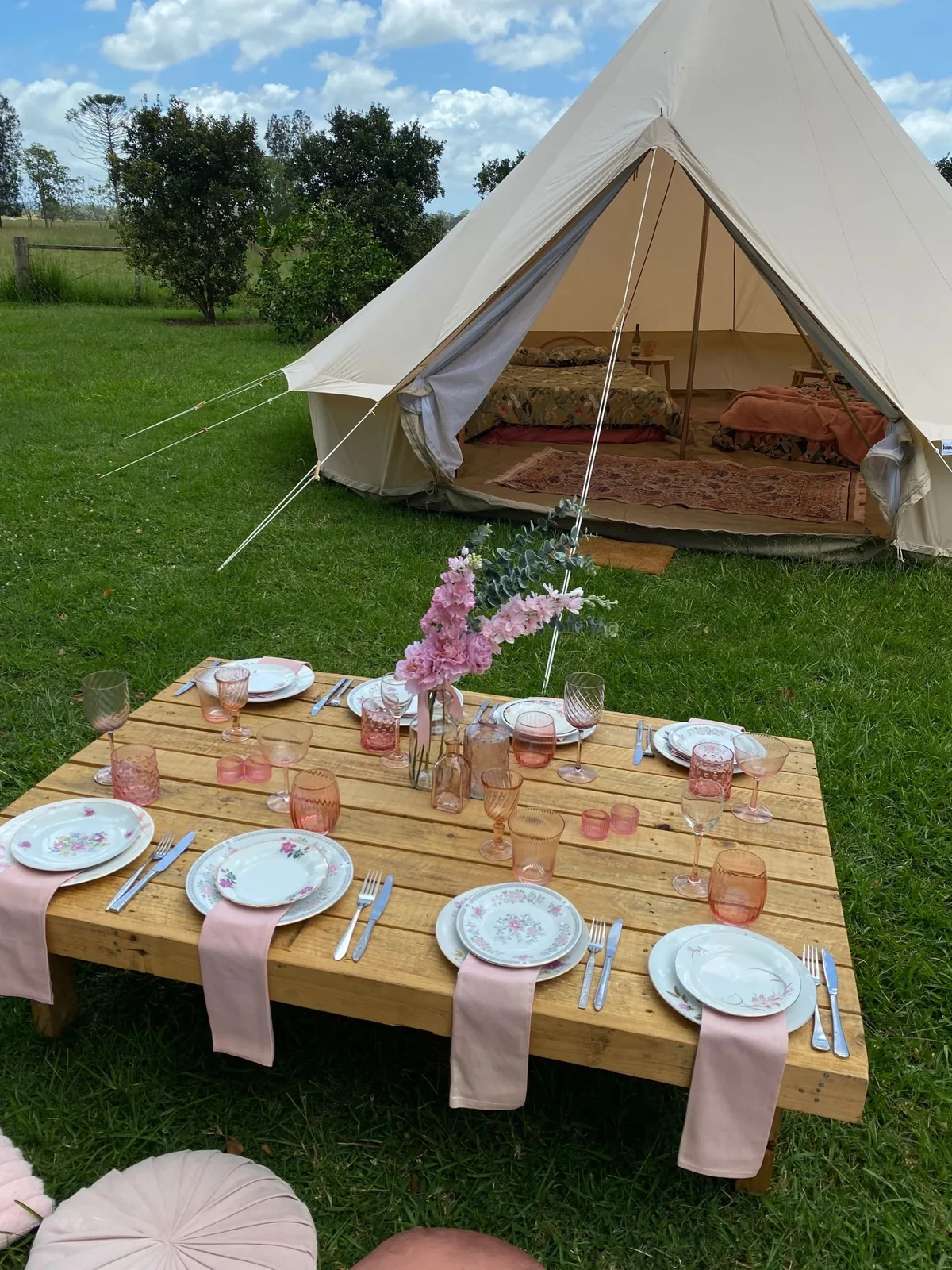 Styled long table setting beside a bell tent